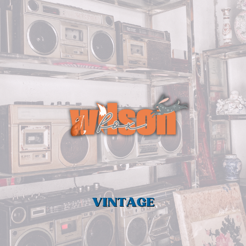 Vintage radios lined up on a wall and a sign that says VINTAGE advertising vintage treasure for sale at Wilson Fox Antiques