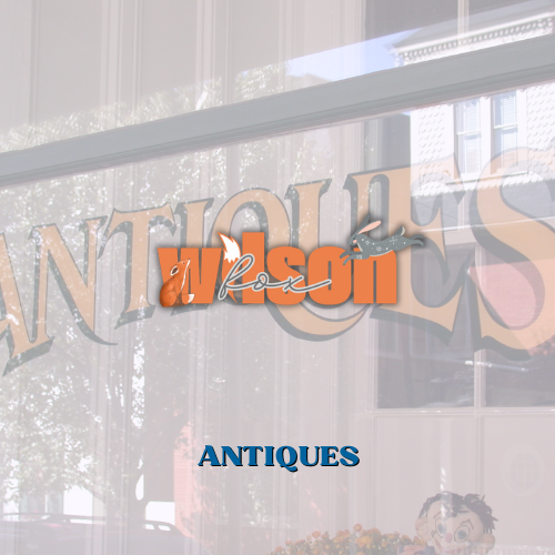 A sign that reads antiques advertising antiques for sale at Wilson Fox Antiques