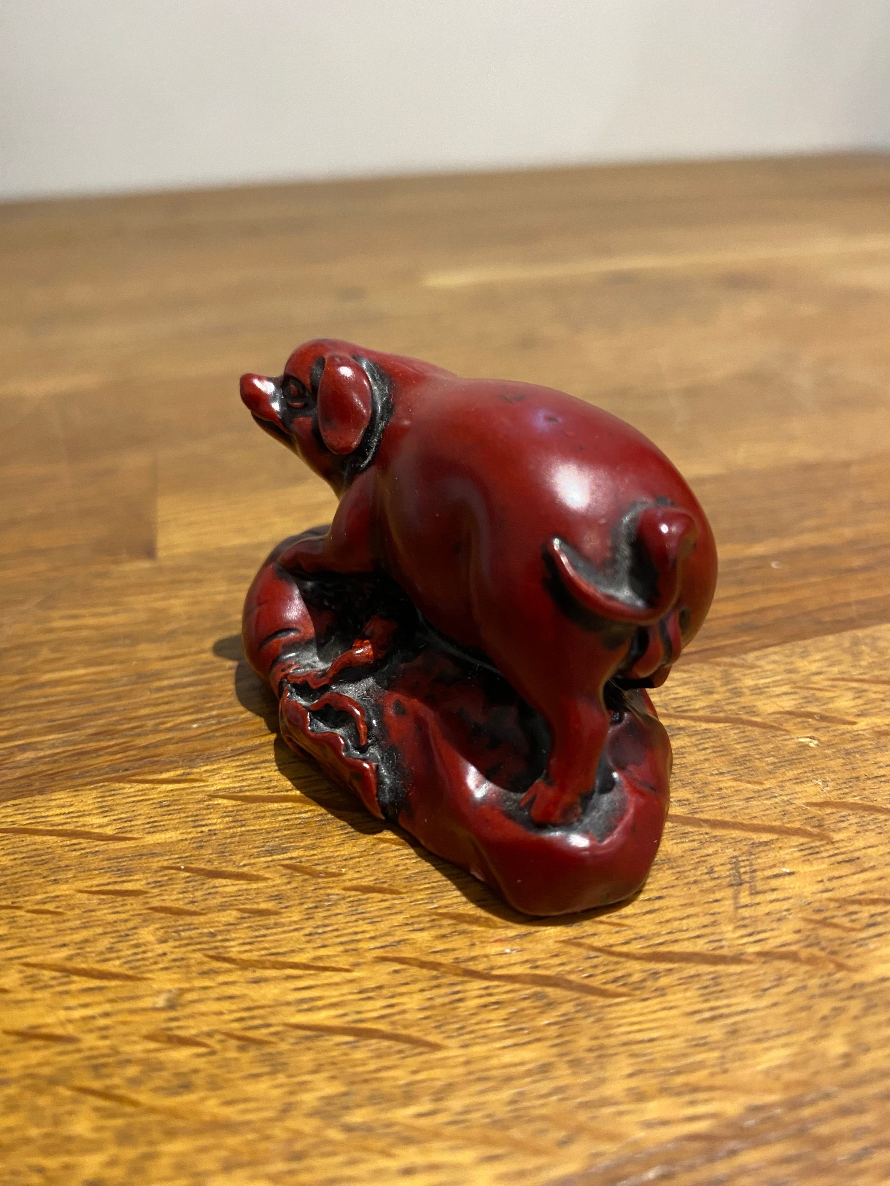 Miniature Chinese year of the pig resin figure.