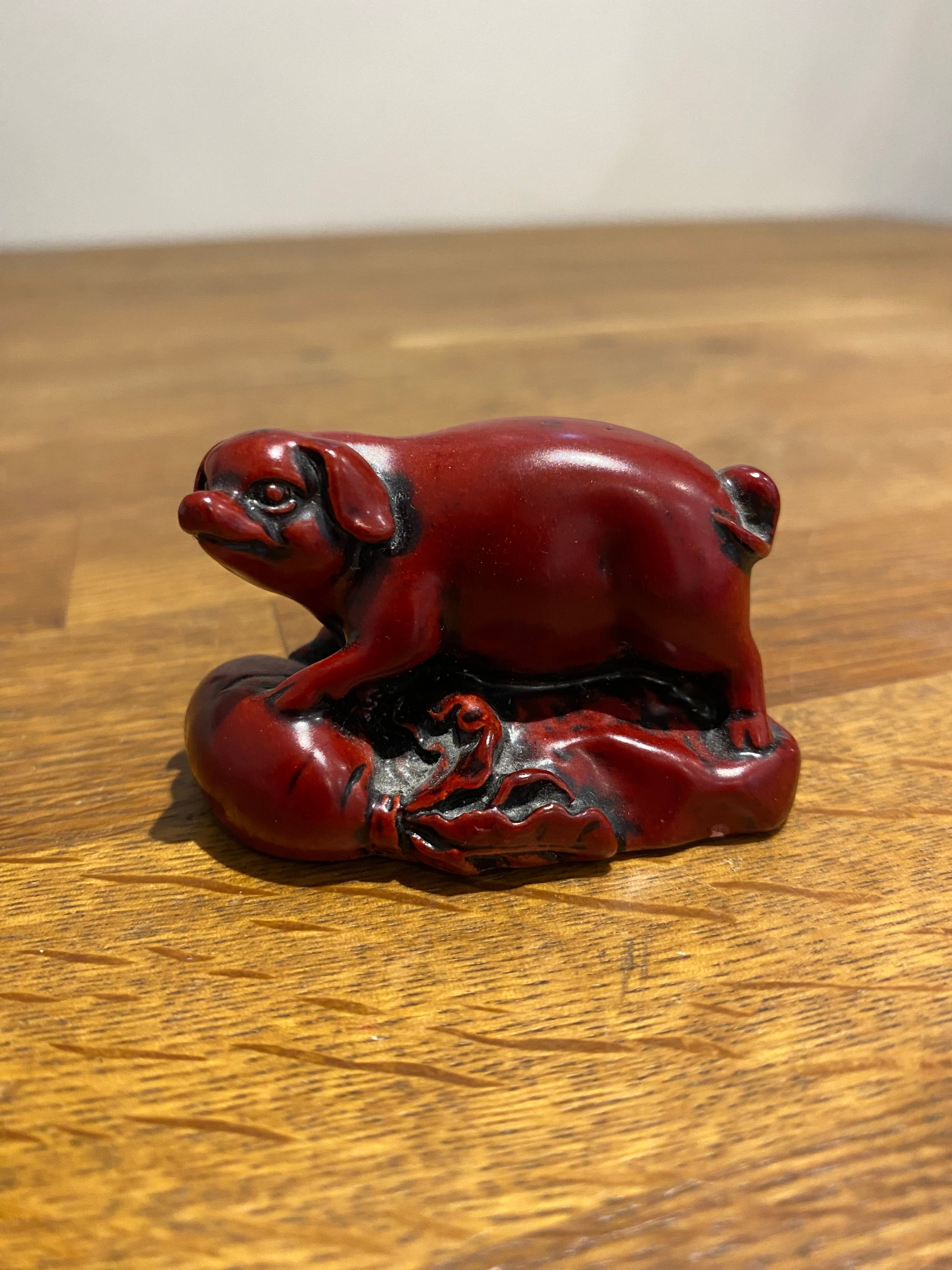 Miniature Chinese year of the pig resin figure.