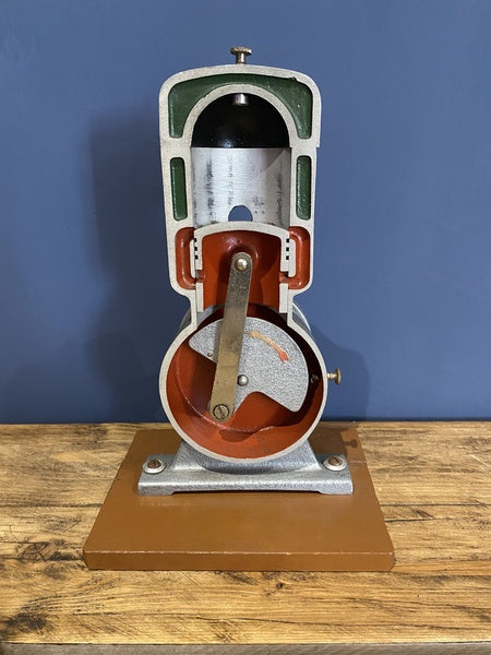 Vintage Cutaway Piston Engine Mounted On A Wooden Base